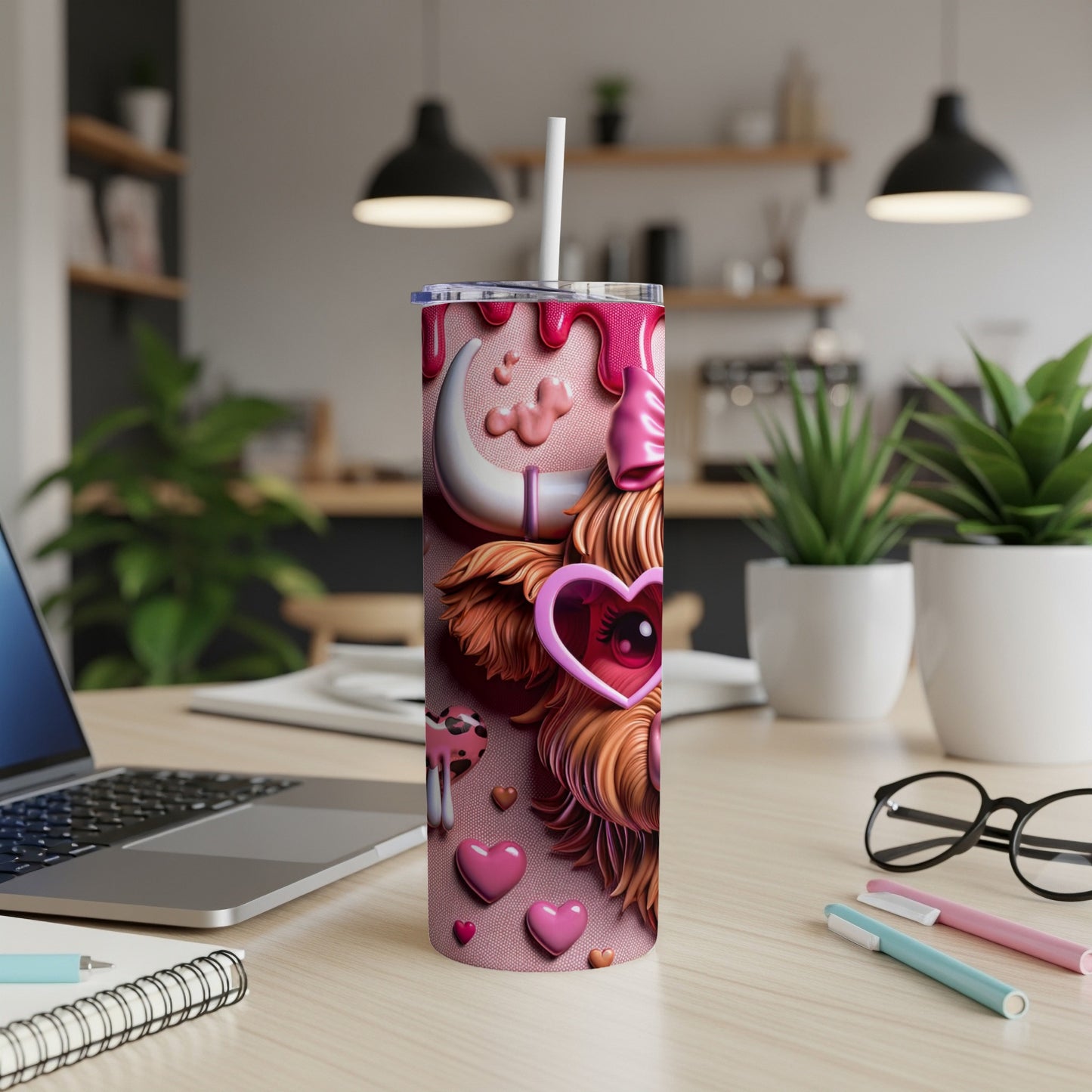 Pink tumbler with a cow design, hearts, and a straw.