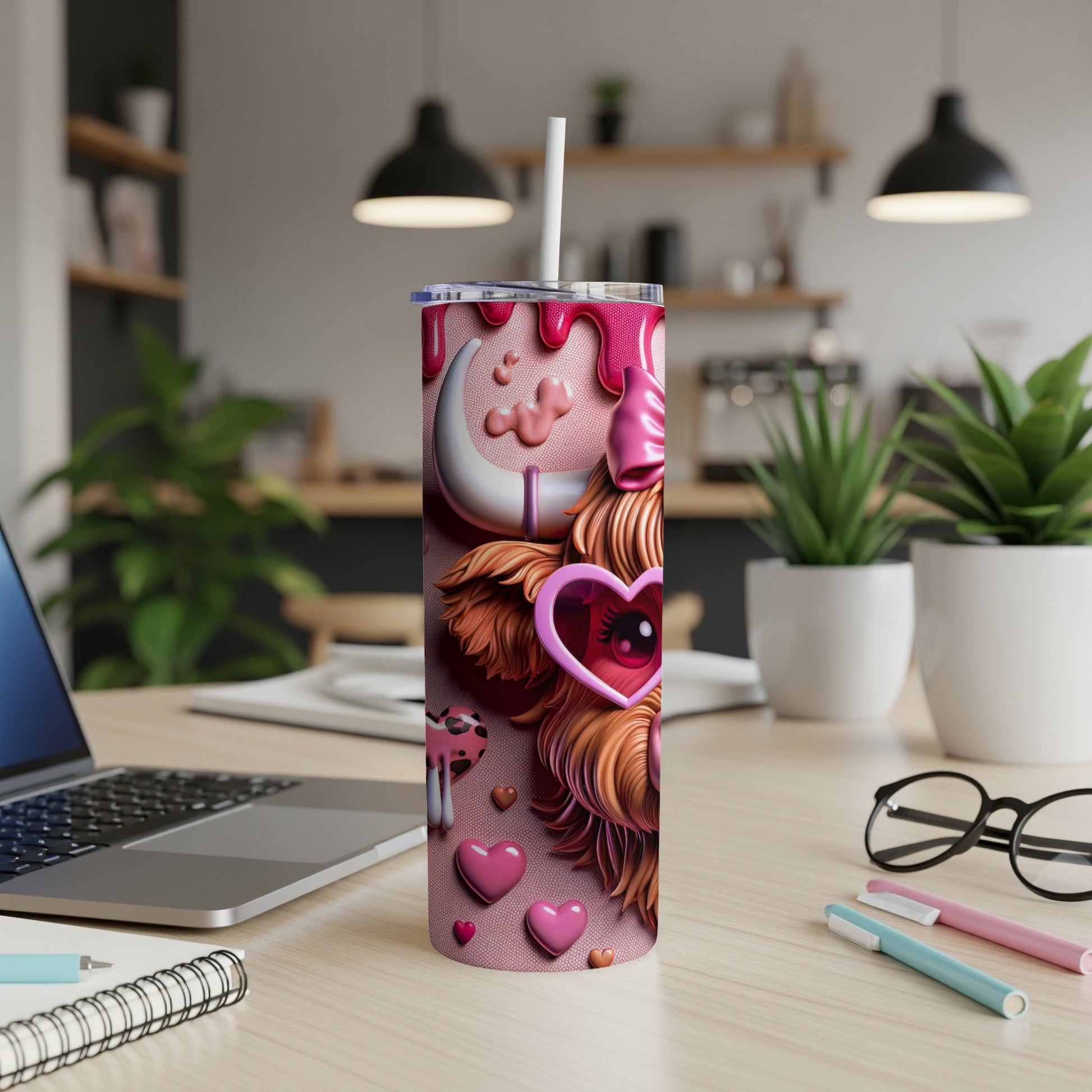 Pink tumbler with a cow design, hearts, and a straw.