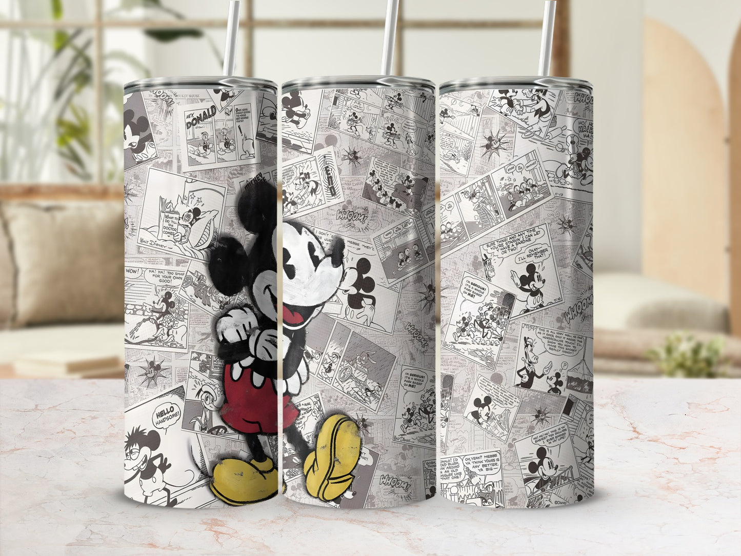 Mickey Mouse cartoon comic panels on a tumbler with a straw.