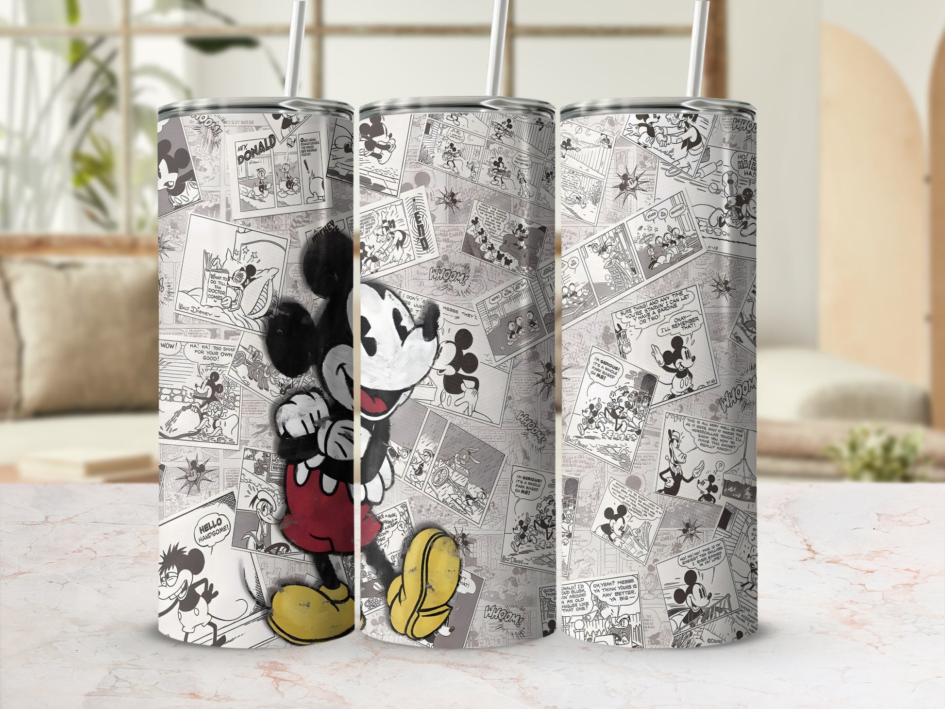 Mickey Mouse cartoon comic panels on a tumbler with a straw.