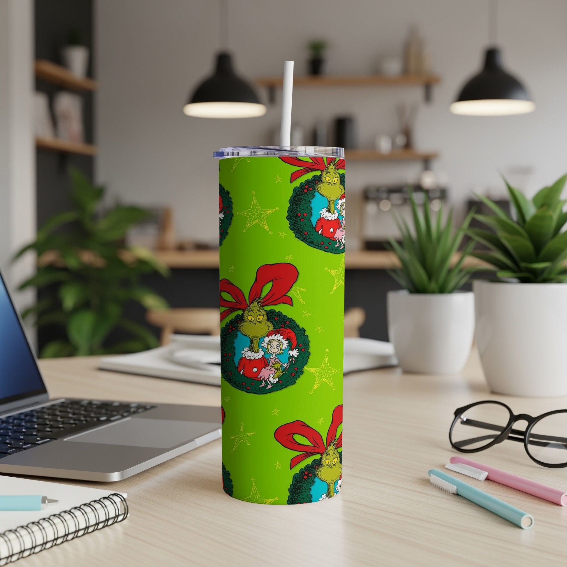 Green tumbler with Grinch characters and red star pattern.