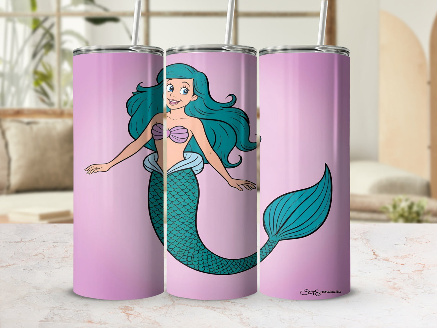 Pink tumbler with a cartoon mermaid and her tail against a light pink background.