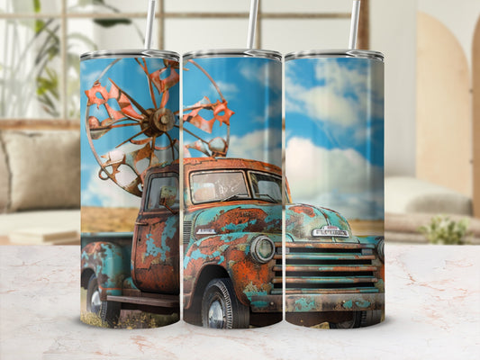 Rusty vintage truck with windmill on a bright, sunny day.