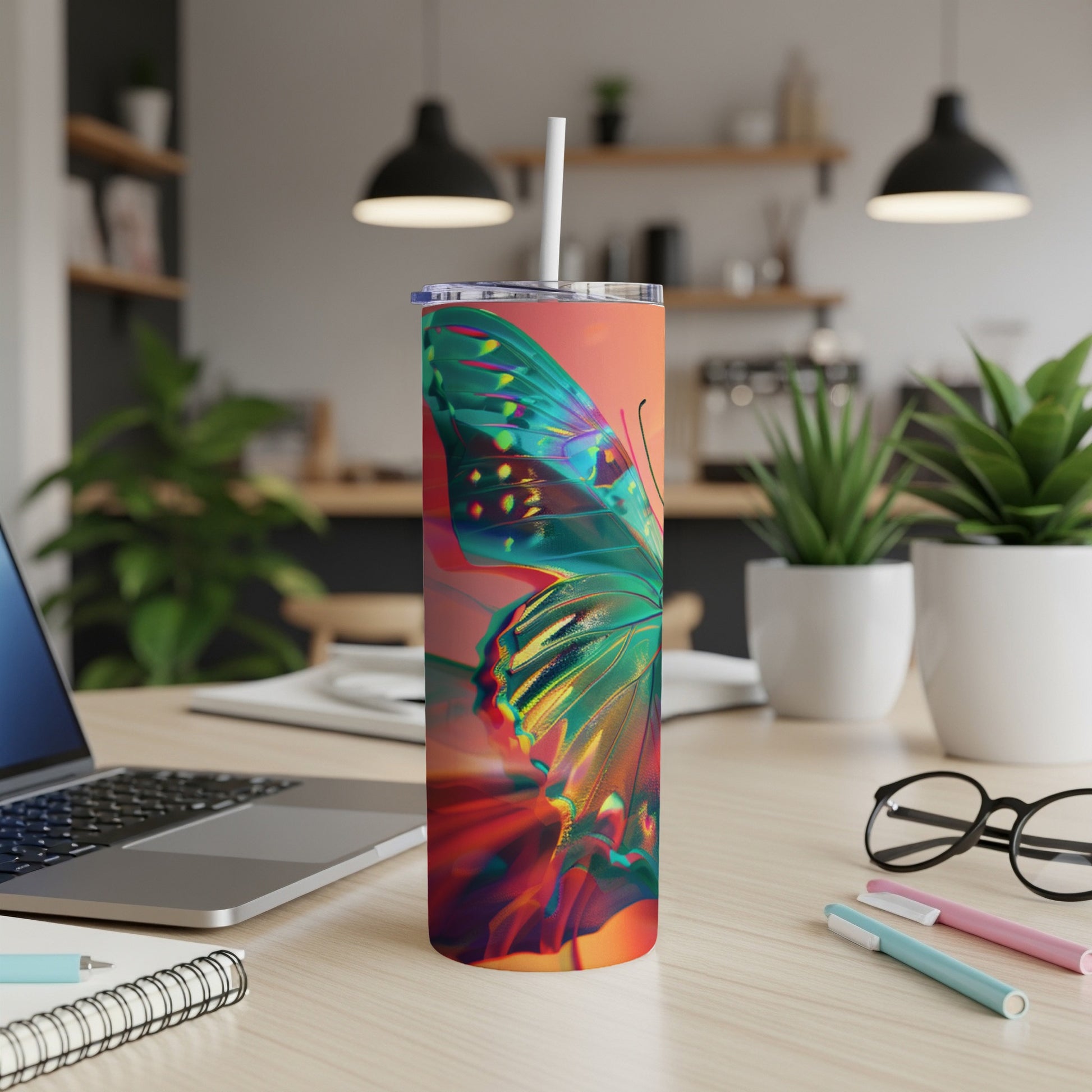 Abstract butterfly design on a tall, insulated tumbler with a straw.