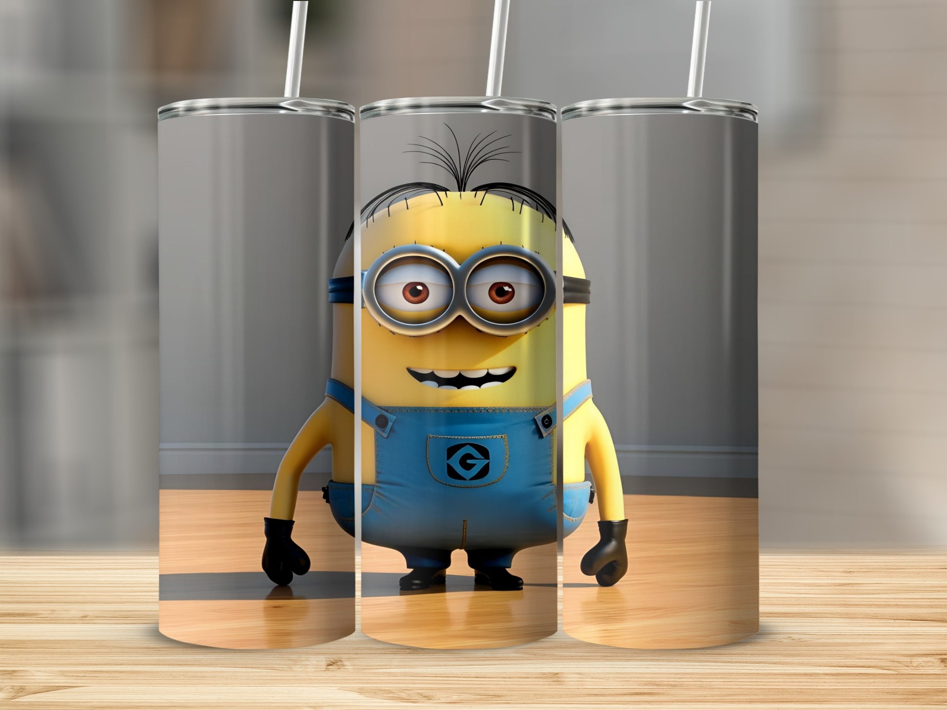 Three skinny tumblers with a cartoon Minion character wearing blue overalls.