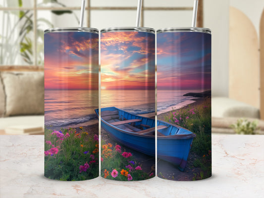 Blue rowboat on a beach with colorful flowers and sunset sky.
