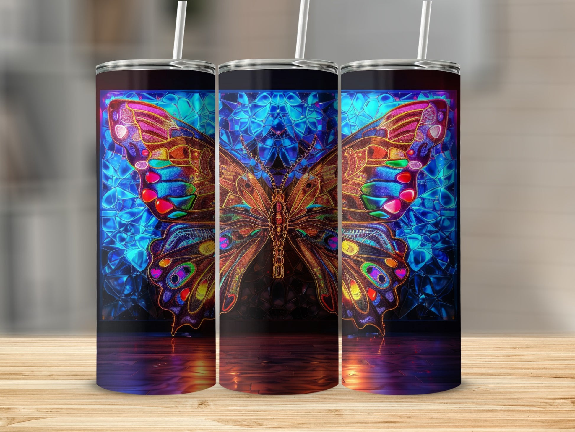 Three tumblers with colorful stained-glass butterfly designs.