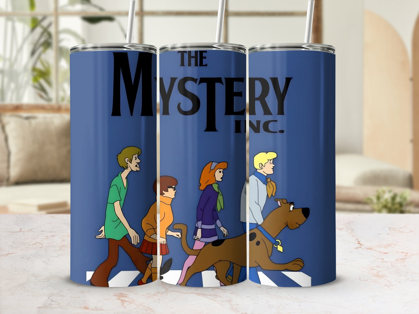 The Mystery Inc. gang and Scooby-Doo on a blue tumbler.