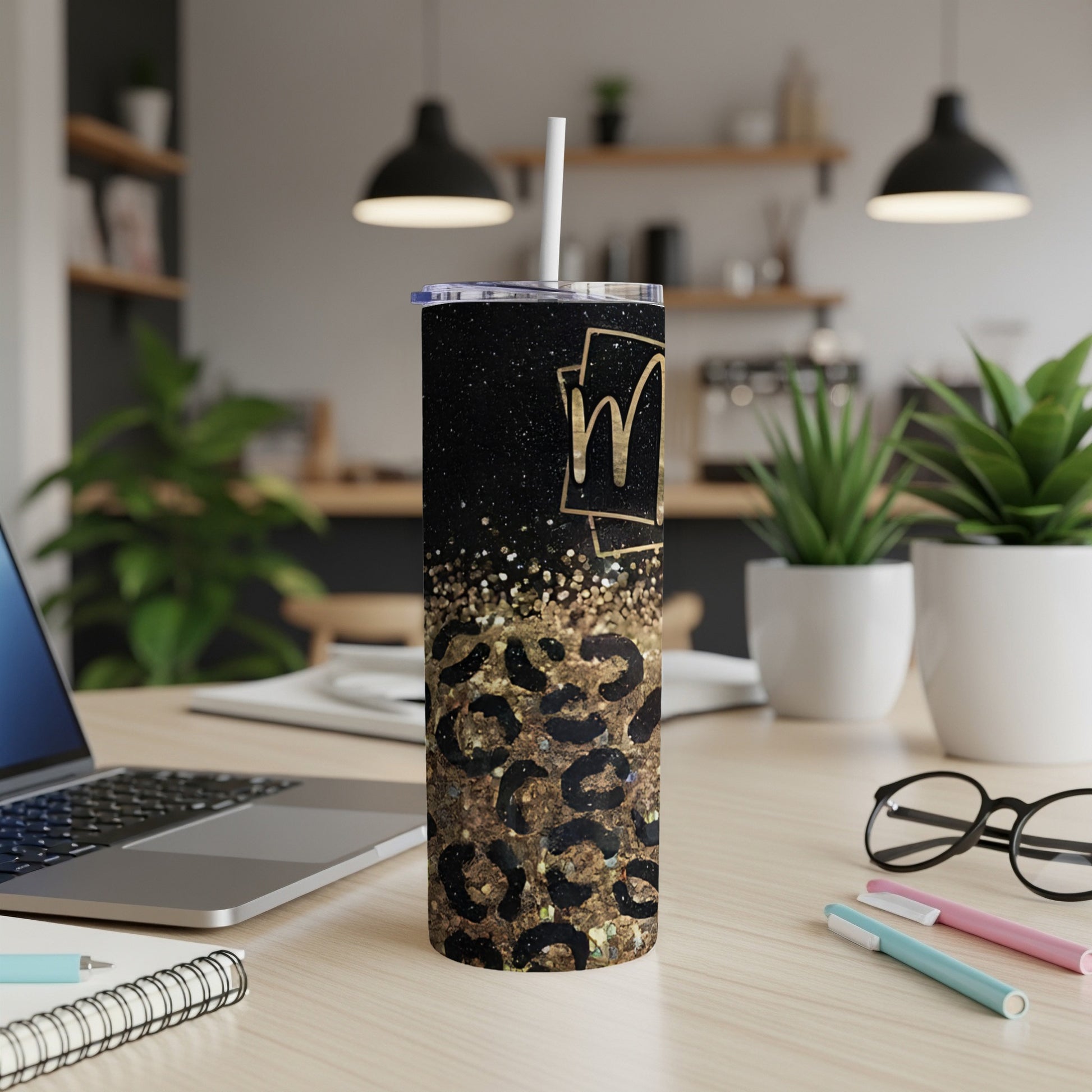 Black glitter tumbler with leopard print and gold "M" monogram.