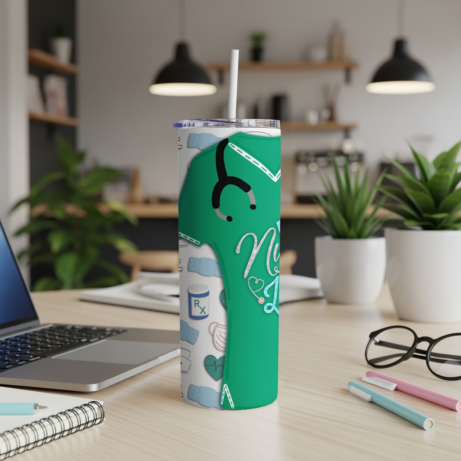Green tumbler with nurse-themed icons and stethoscope, standing on a desk.