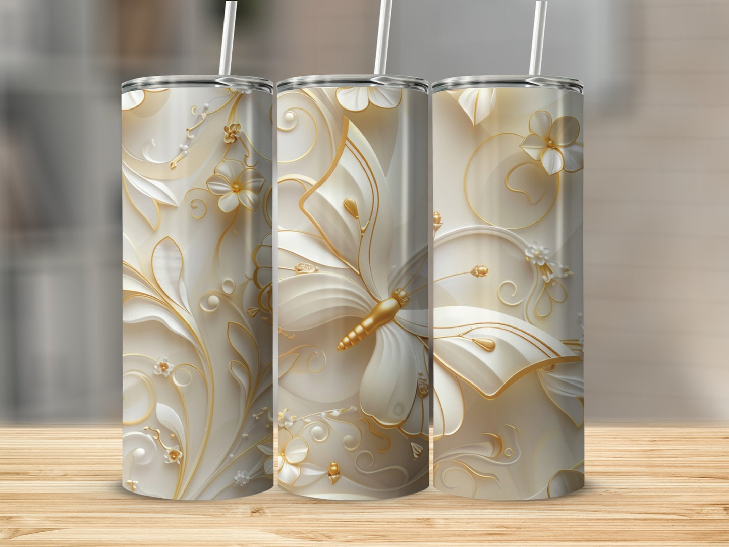 Three tall tumblers with white and gold floral and butterfly embossed designs.