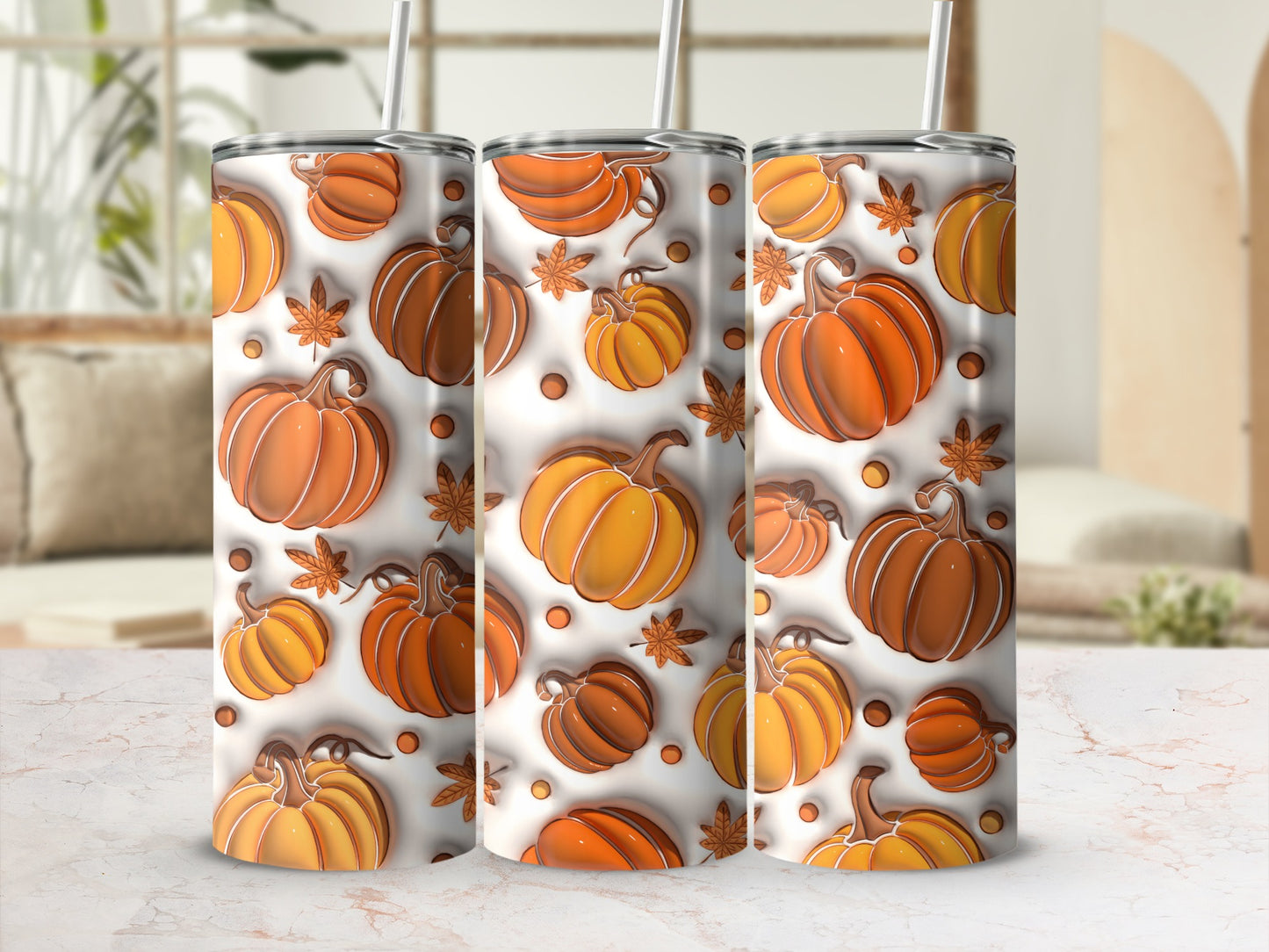 Three tumblers with a pumpkin and leaf pattern.