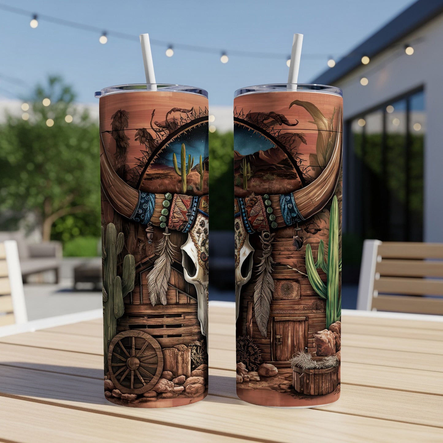 Cow skull and desert scene on two tall, skinny tumblers with straws.