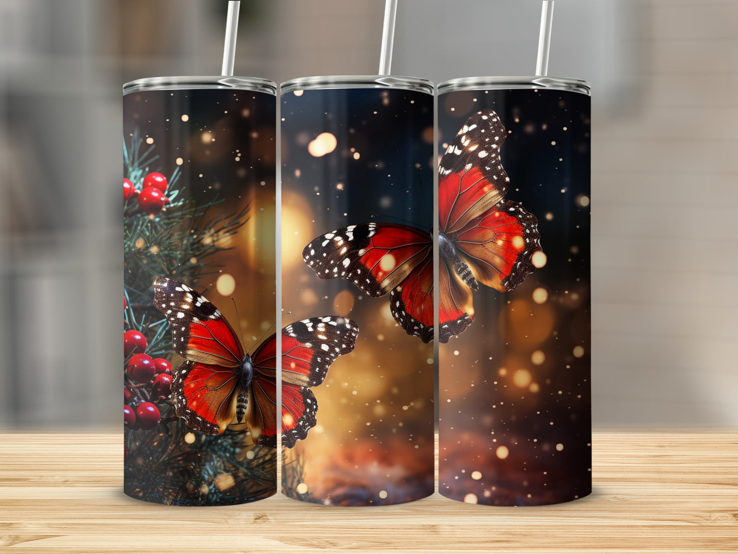 Three tumblers with vibrant red butterflies and festive holiday greenery.