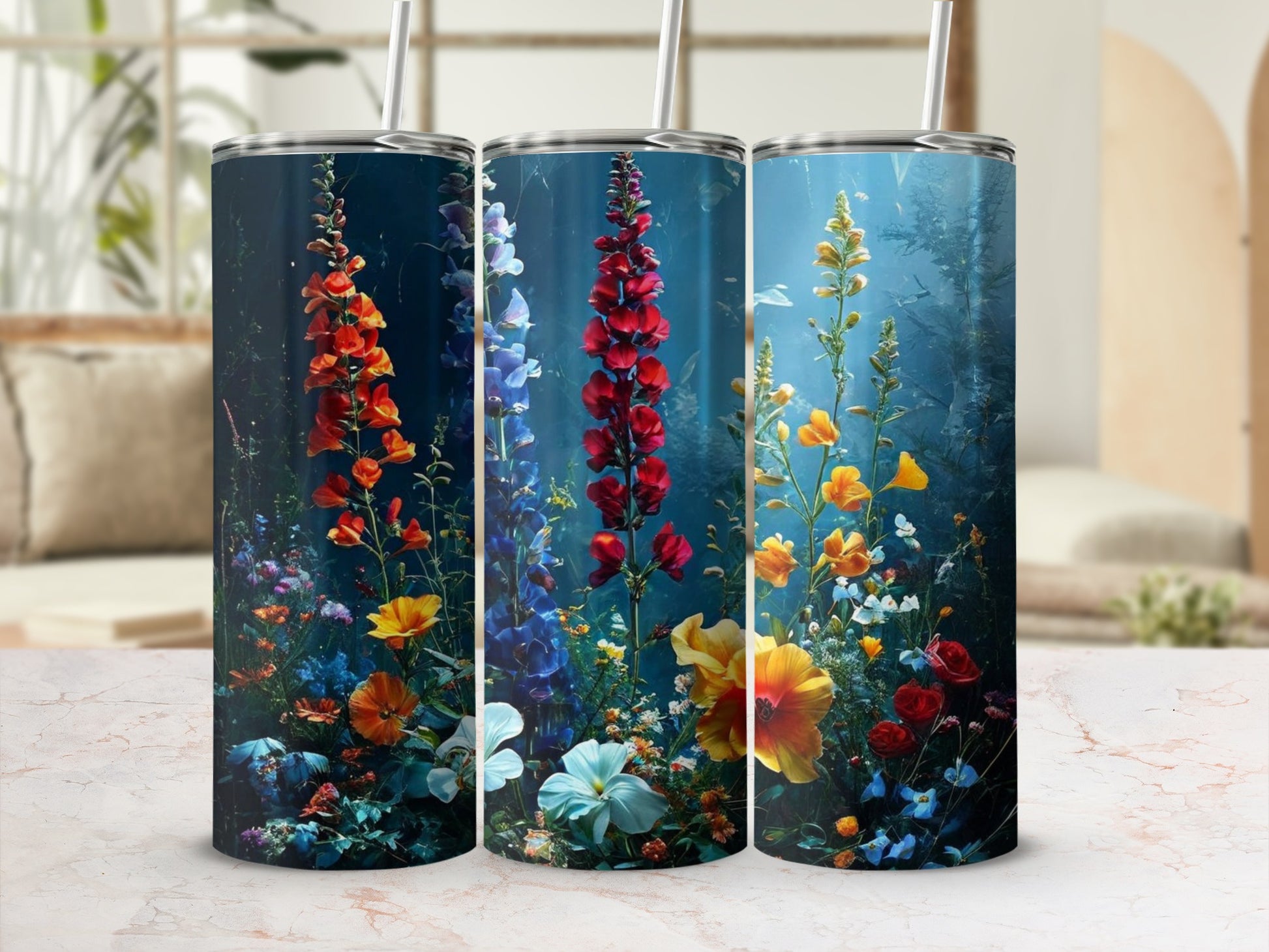 Three tumblers feature colorful floral designs with tall stalks and small blossoms.