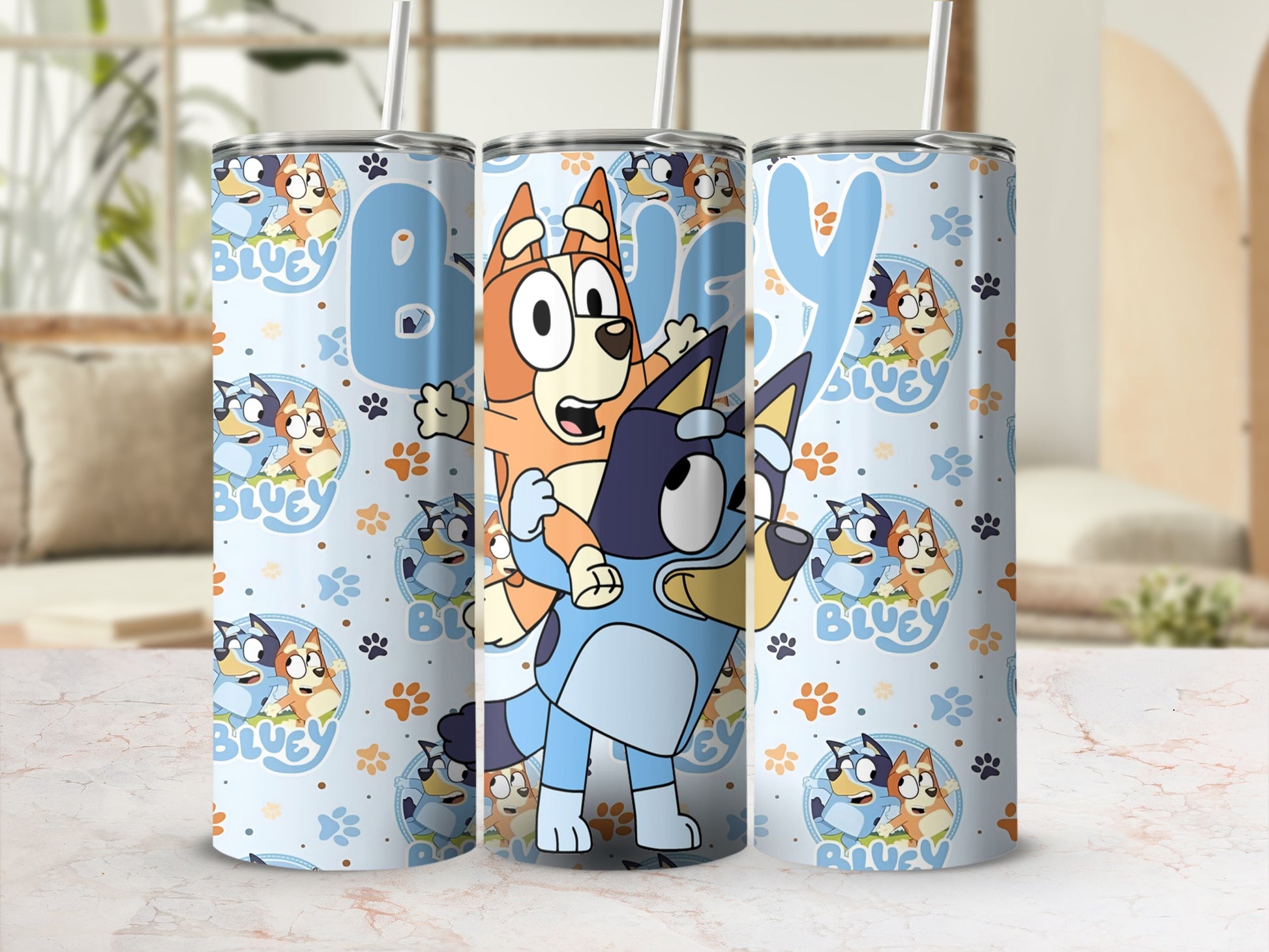 Bluey and Bingo characters on a pale blue tumbler with blue paw prints.