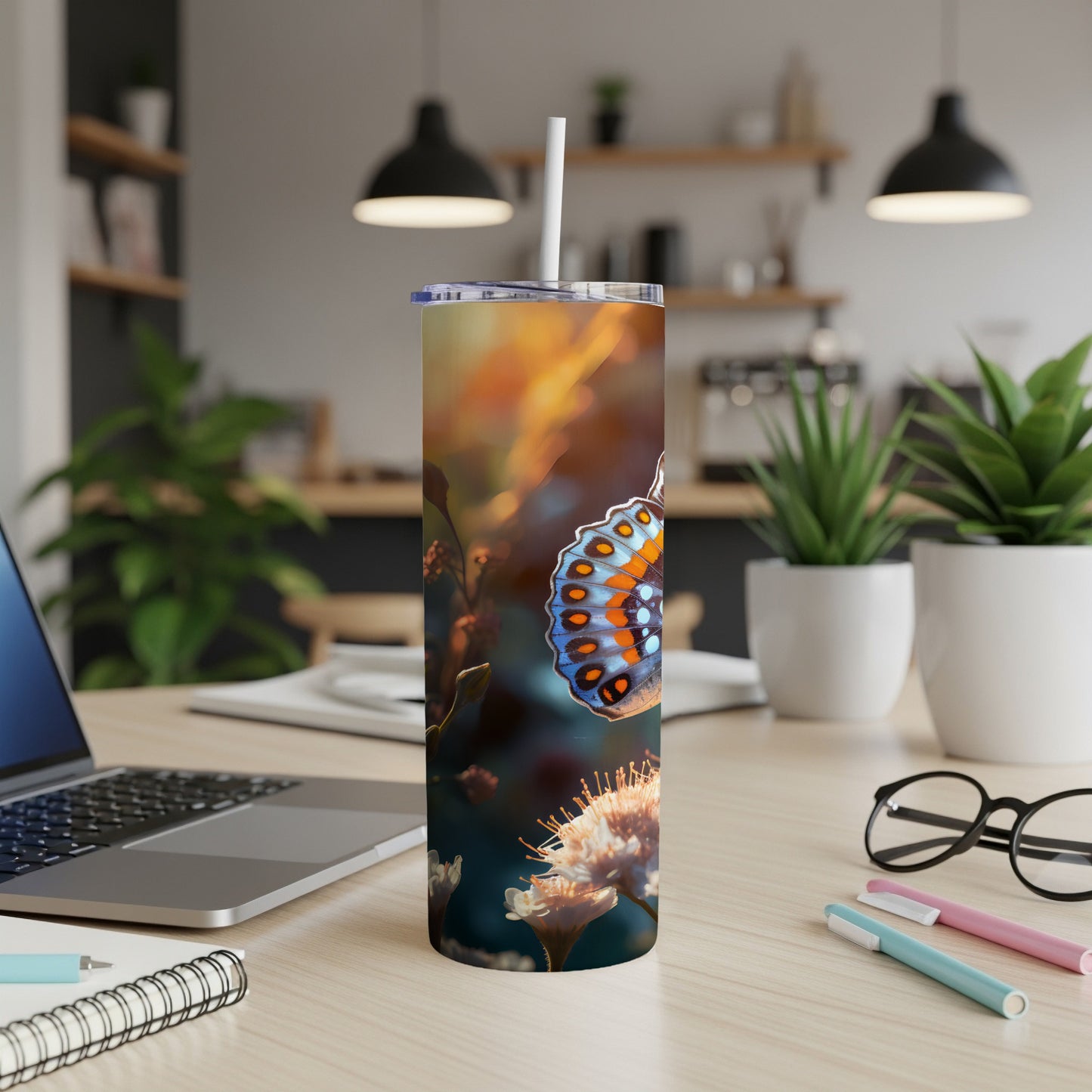 Butterfly on a floral background wrapping a stainless steel tumbler with a straw.