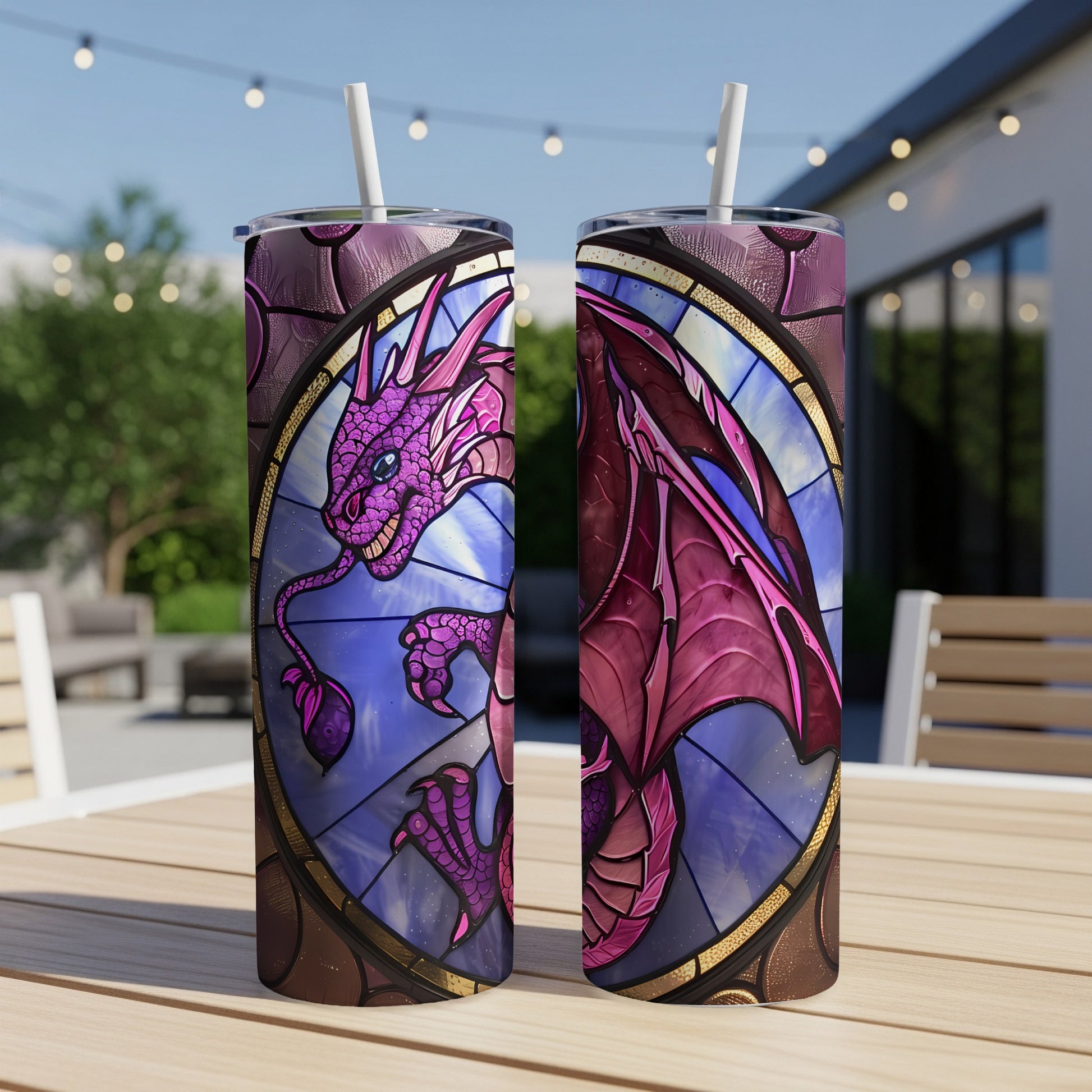 Stained glass dragon tumbler with straw on outdoor table.