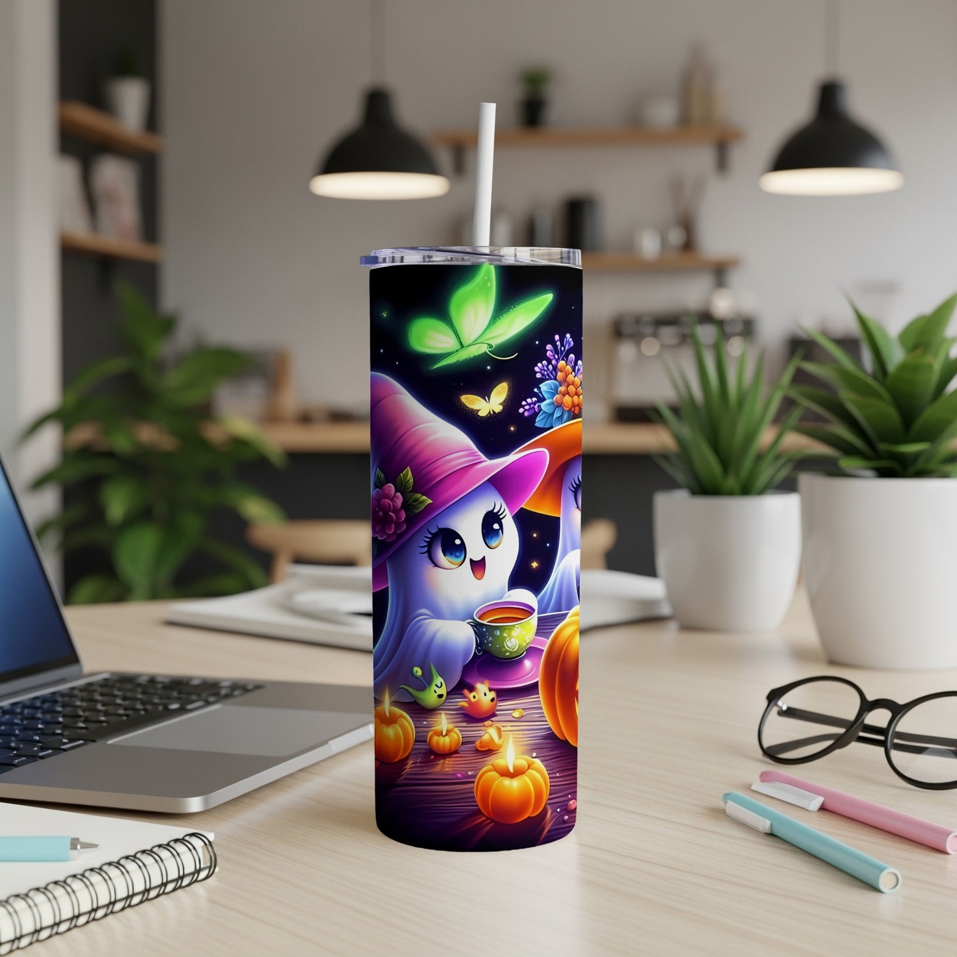 Tumbler with cute ghost and butterflies, surrounded by pumpkins and candles.