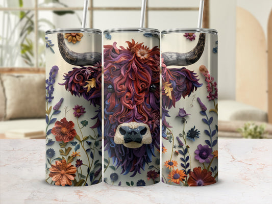 Tumbler featuring a stylized, floral Highland cow face with horns and colorful blossoms.