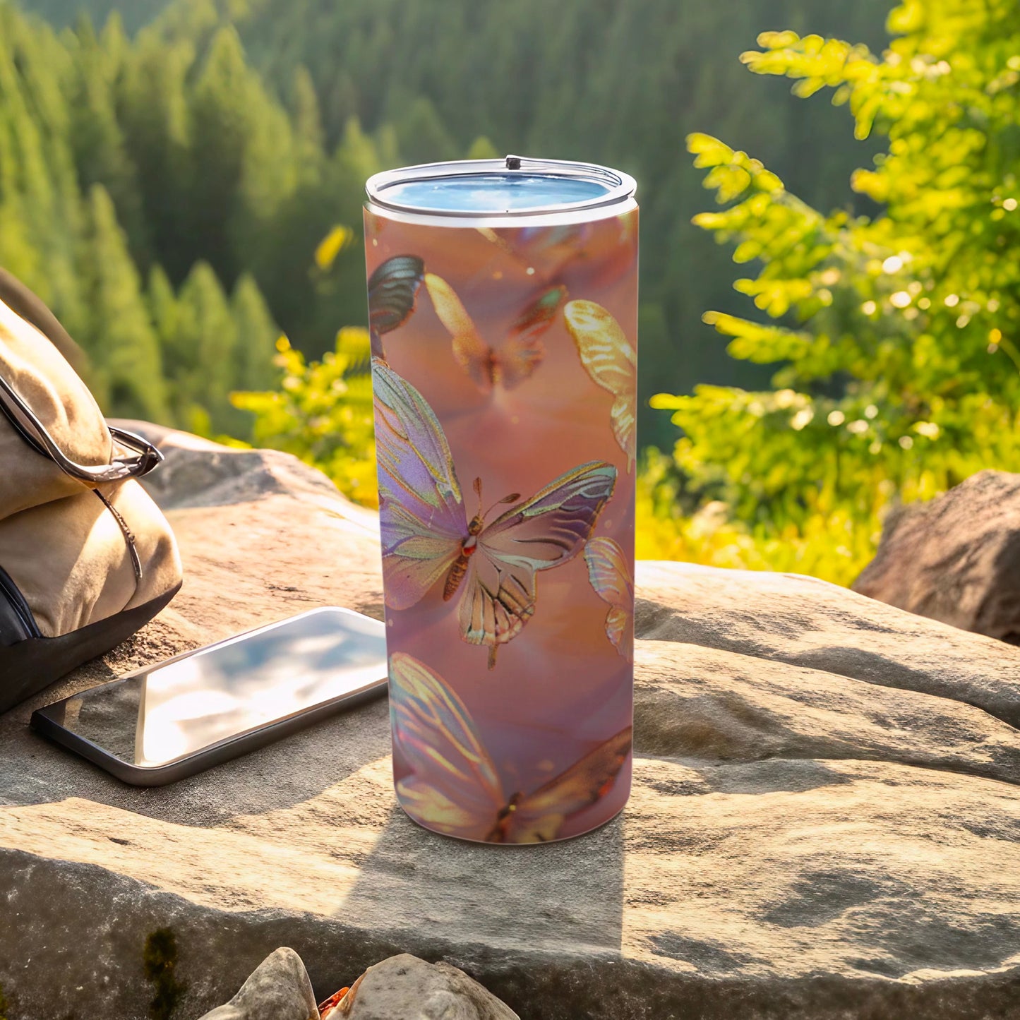 Tumbler with pastel butterflies and a mountainous forest background.
