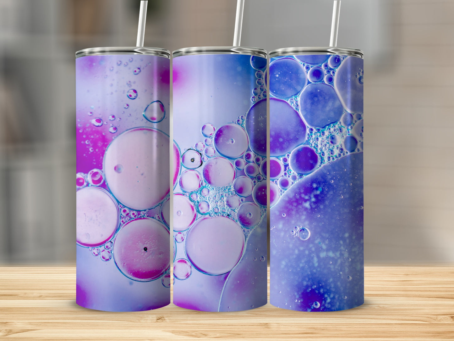 Three tumblers with colorful oil and water bubble pattern.