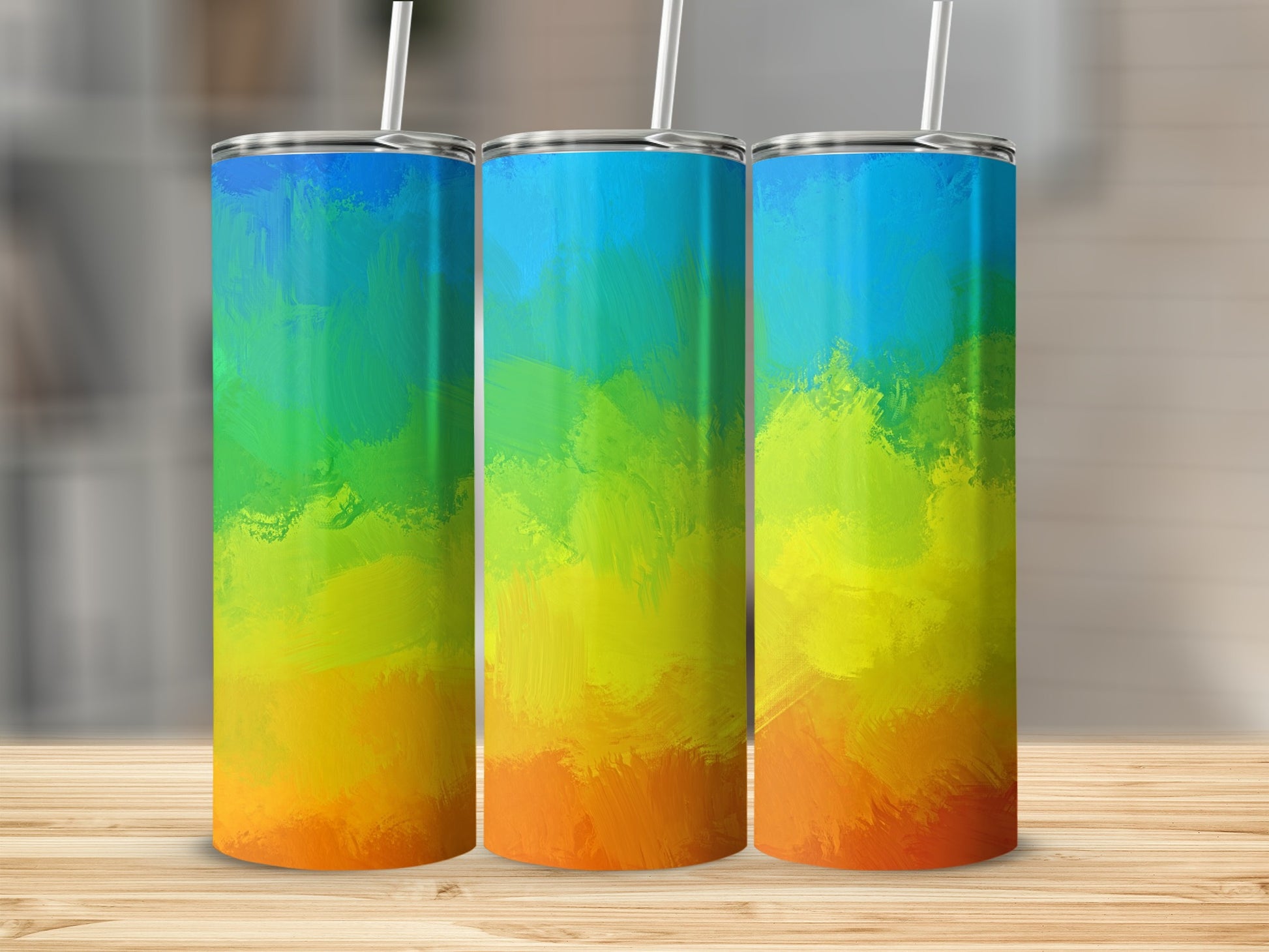 Three tumblers with a vibrant, abstract rainbow gradient design.