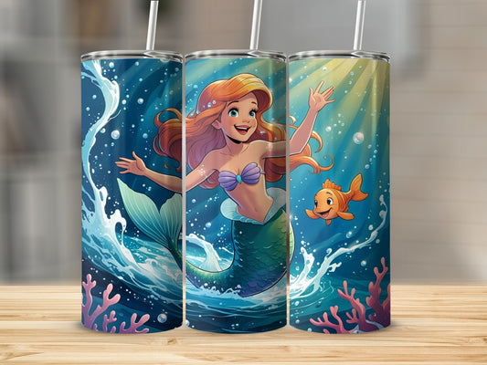 Ariel the mermaid with a fish and coral, on a blue and green tumbler.