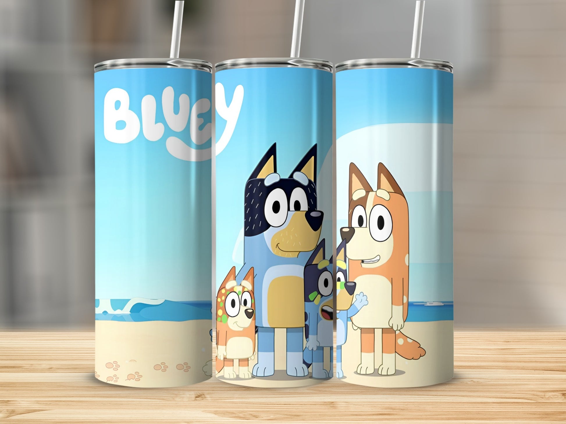 Bluey and Bingo characters on a beach-themed tumbler with "Bluey" text.