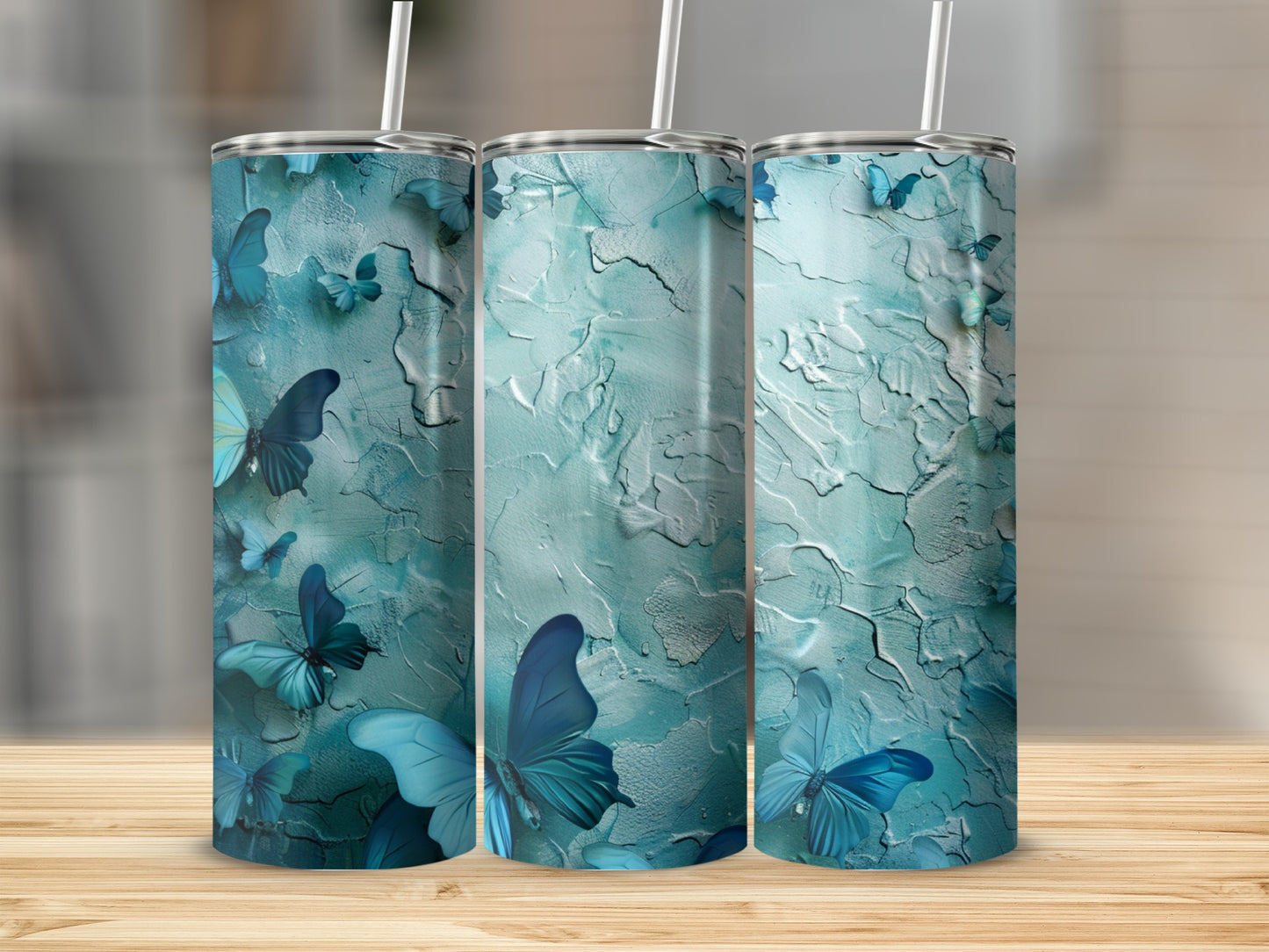 Three tumblers with a textured teal background and blue butterflies.