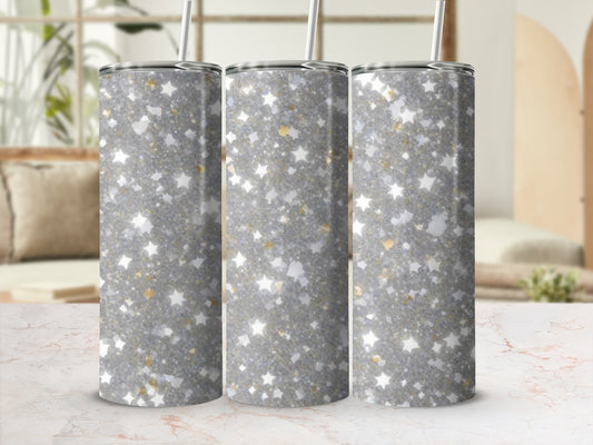 Three sparkly glitter tumblers with star accents on a marble surface.