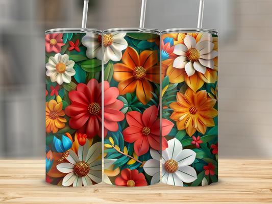 Three tumblers with vibrant floral patterns on a wooden surface.