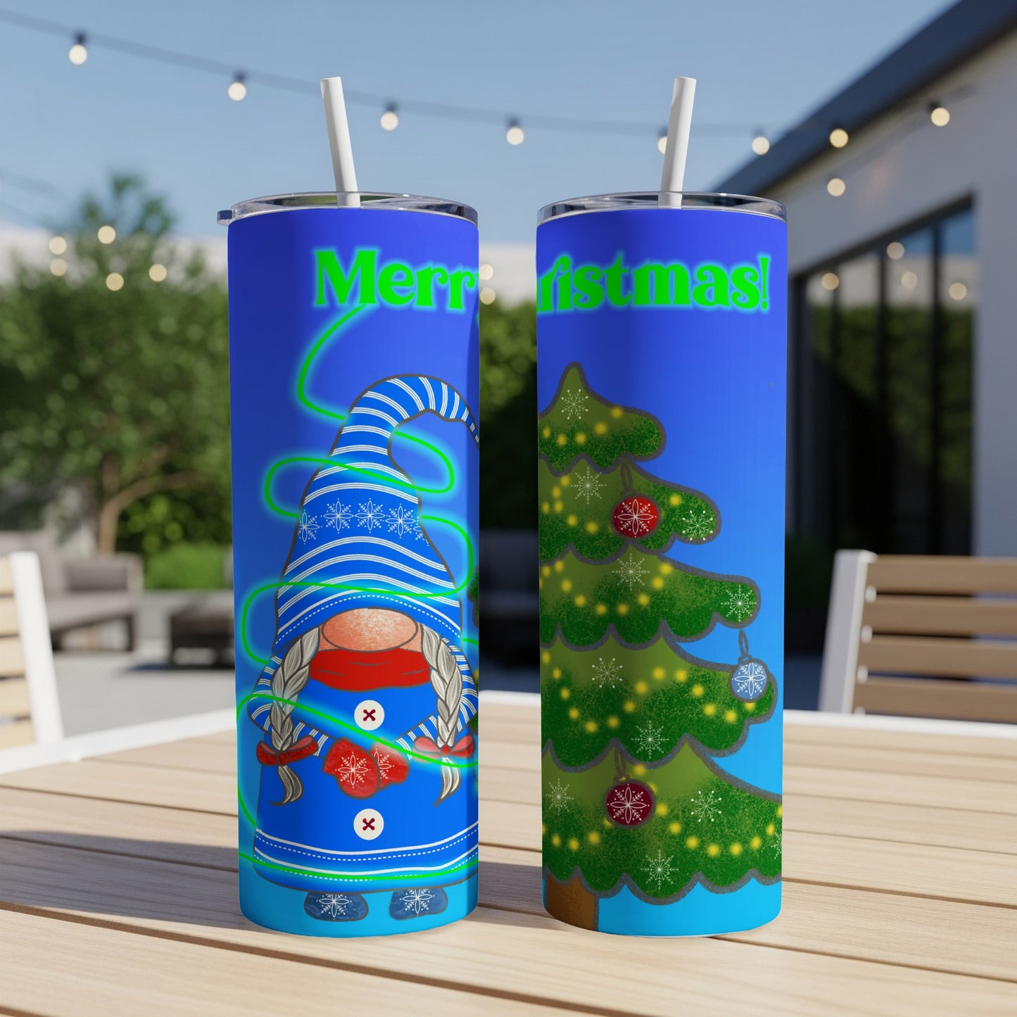 Two blue tumblers with Christmas designs, one with a gnome, the other with a tree.