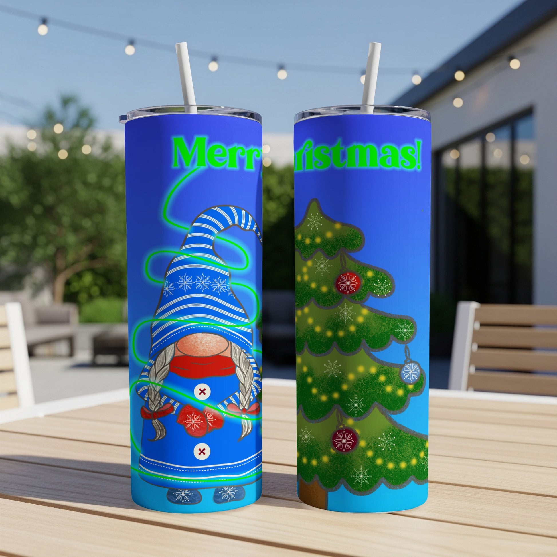 Two blue tumblers with Christmas designs, one with a gnome, the other with a tree.