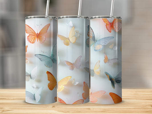 Three tumblers with a colorful butterfly design and straw.