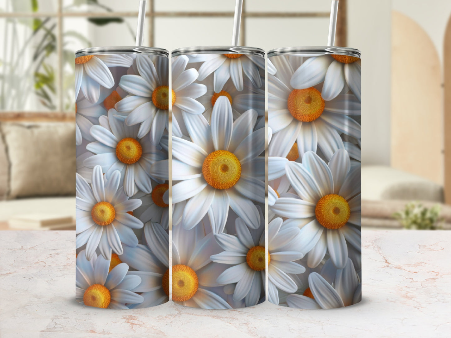 Three tumblers with a repeating daisy floral pattern on a marbled surface.
