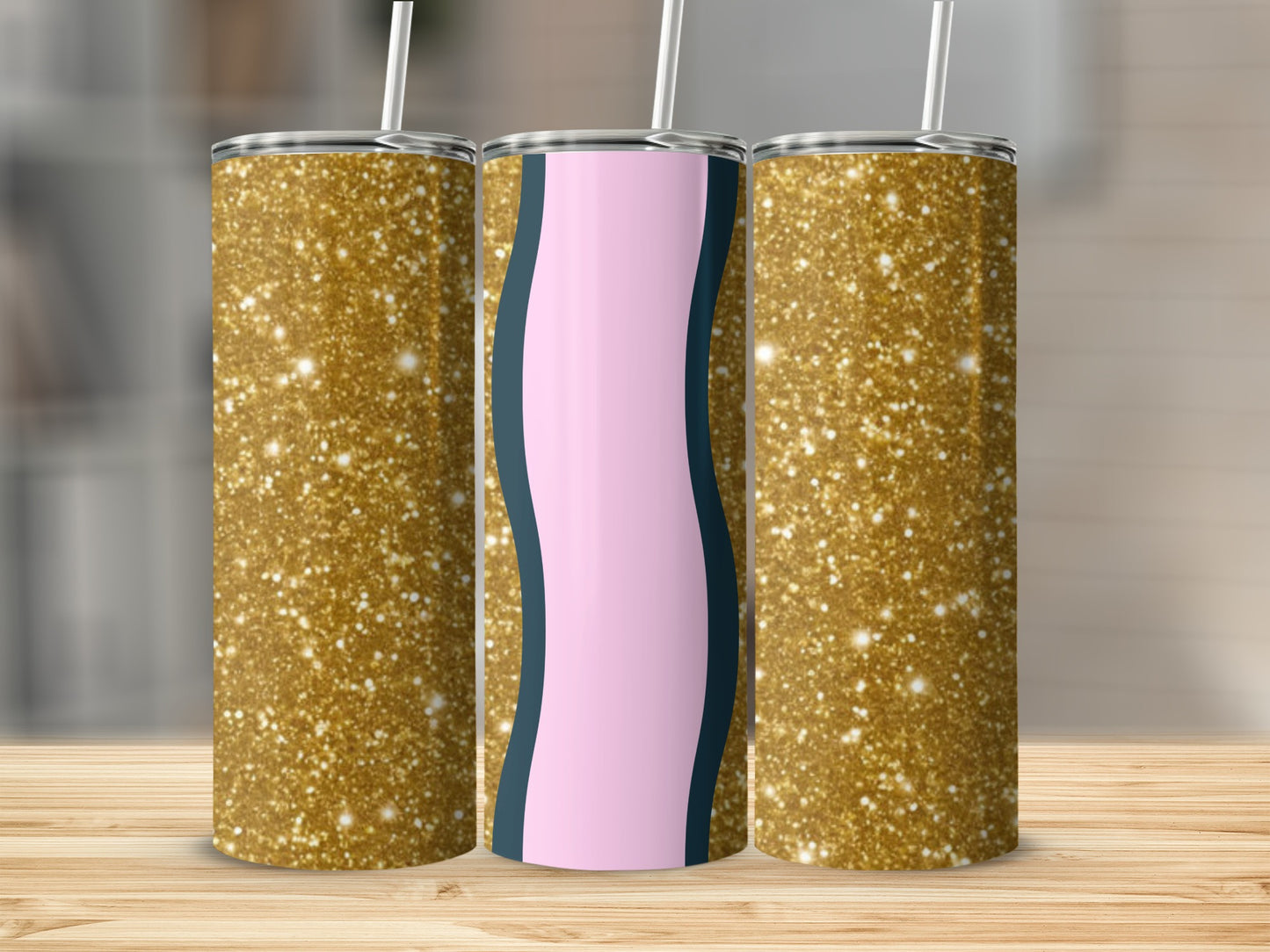 Three glitter tumblers on a wooden surface.