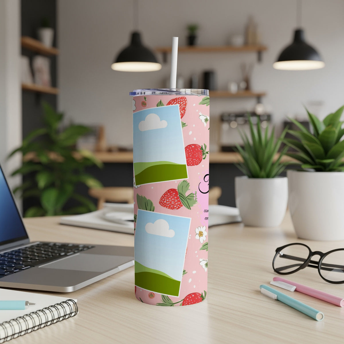 Pink tumbler with strawberries and photo placeholders on a desk.