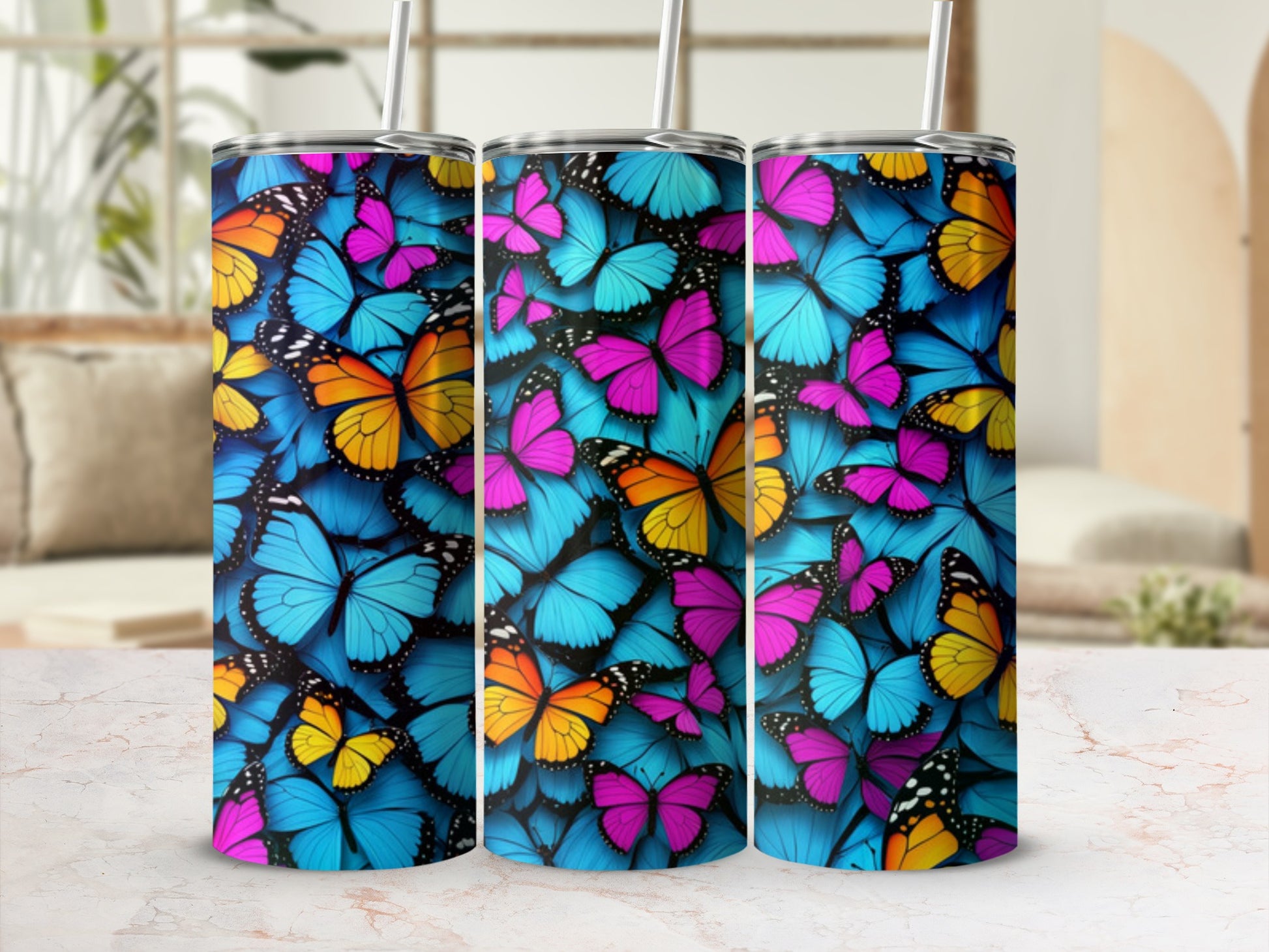 Collage of three tumblers featuring vibrant blue, pink, and orange butterfly patterns.
