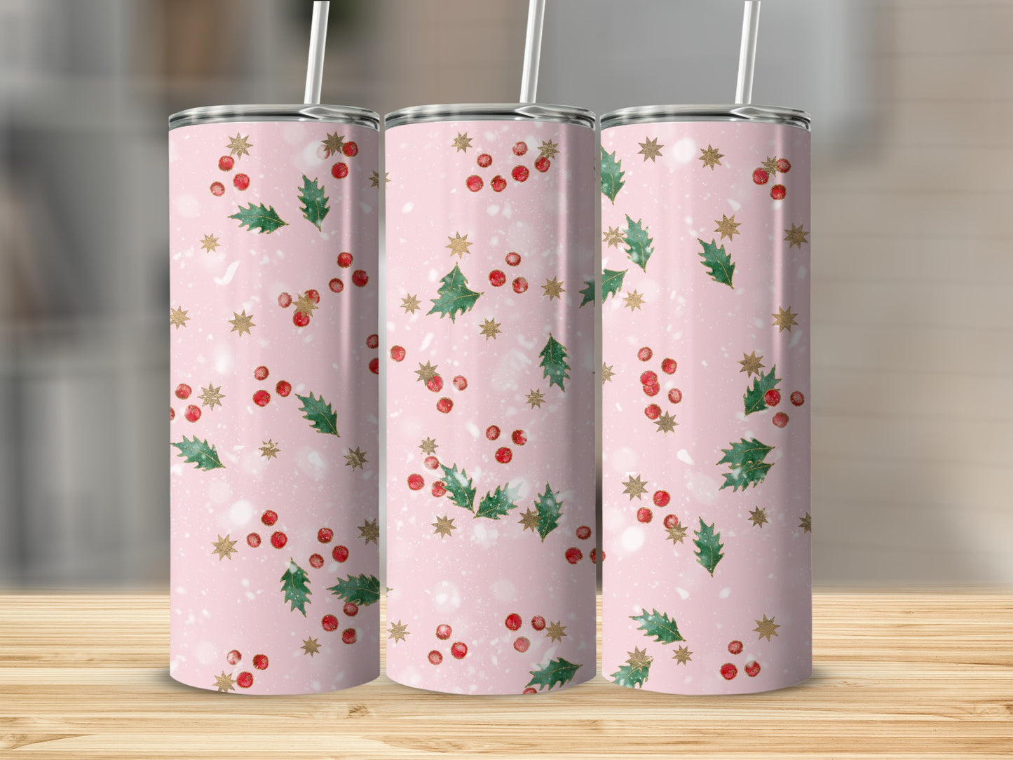 Three pink tumblers with holly and gold star holiday pattern.
