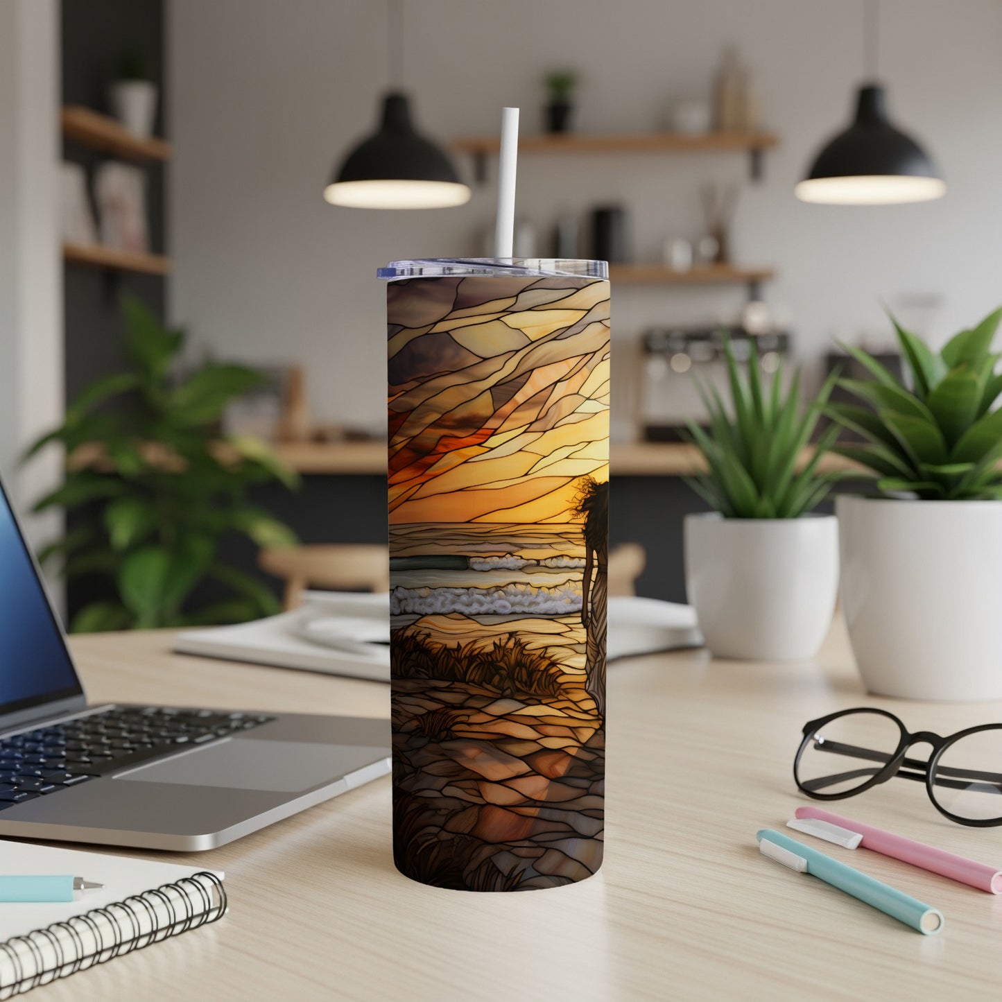 Sunset beach scene on a white tumbler with a straw.