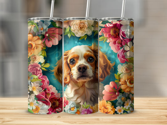 Cavalier King Charles Spaniel surrounded by vibrant floral arrangements.