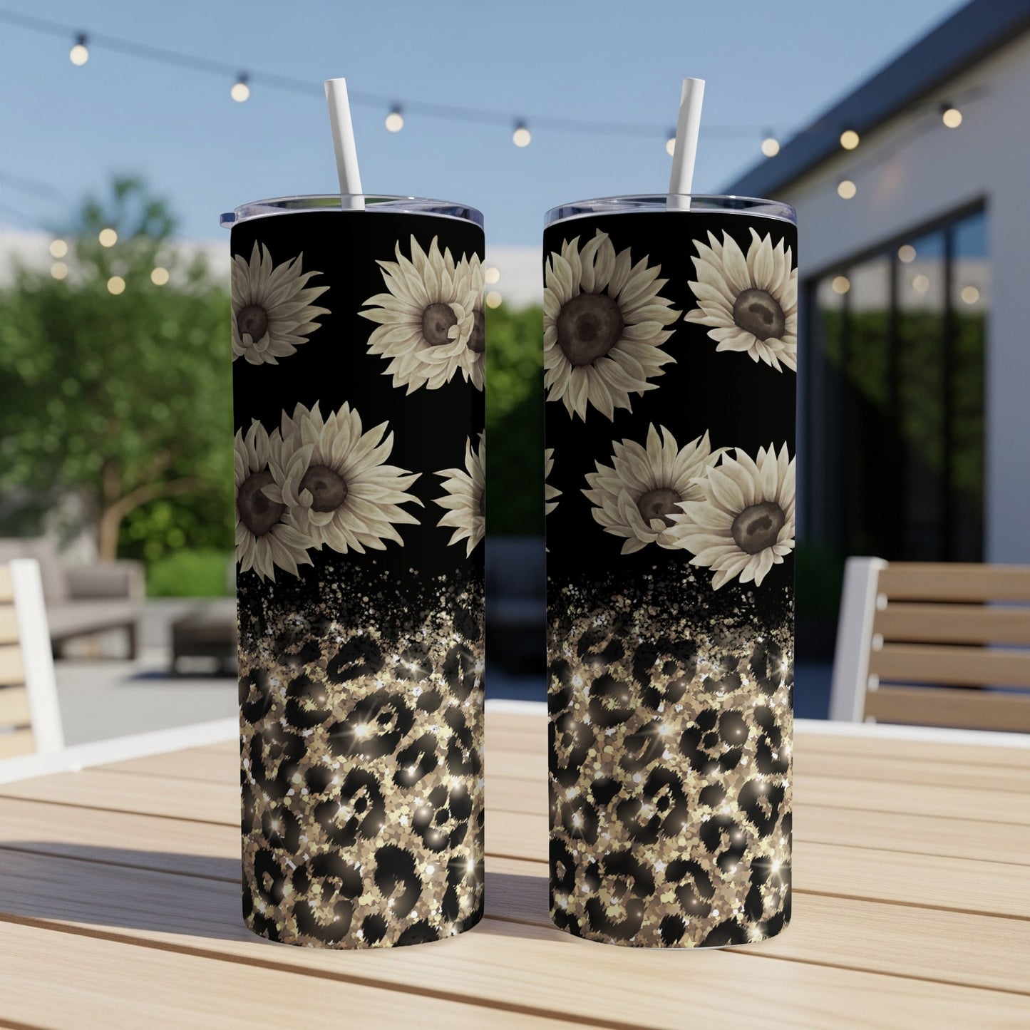 Two tumblers with sunflowers and leopard print designs on a table.