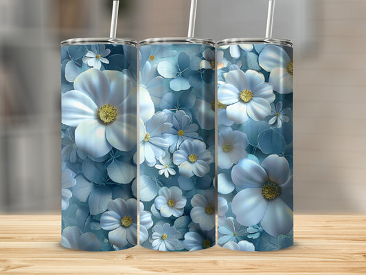 Three tumblers with a pale blue floral pattern sit on a wooden surface.