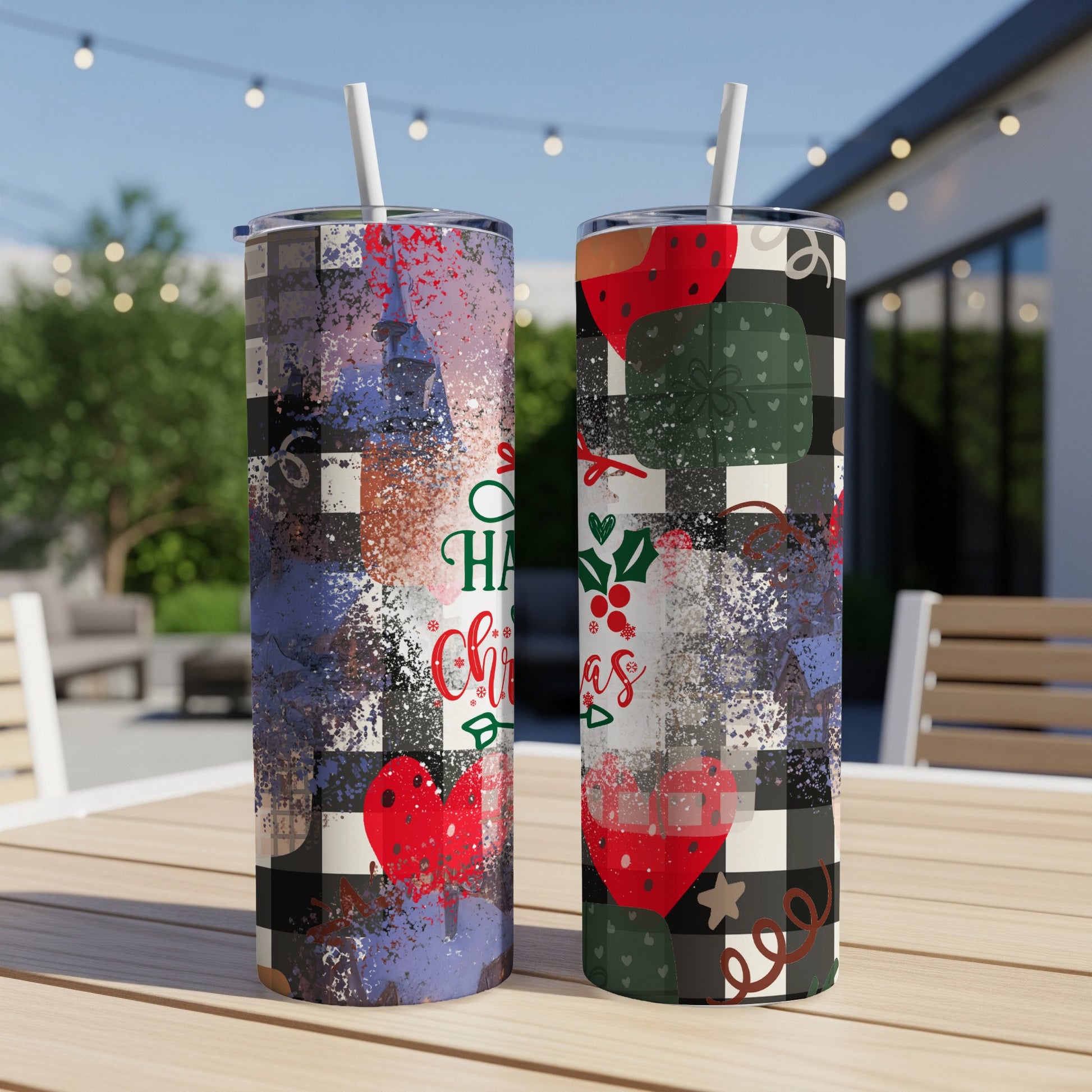 Two tumblers with Christmas designs and glitter on a table.