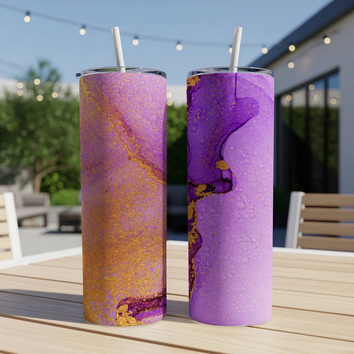 Two tall tumblers with purple and gold abstract marbled patterns and straws.