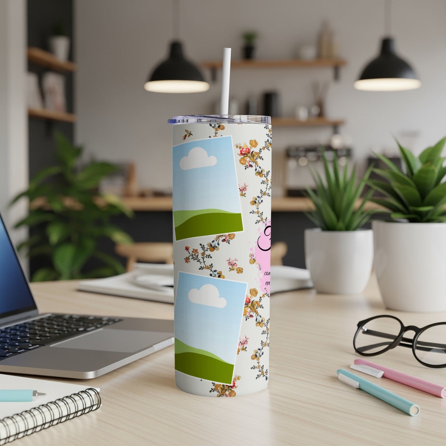Tumbler with floral pattern and two photo placeholders, on a desk.