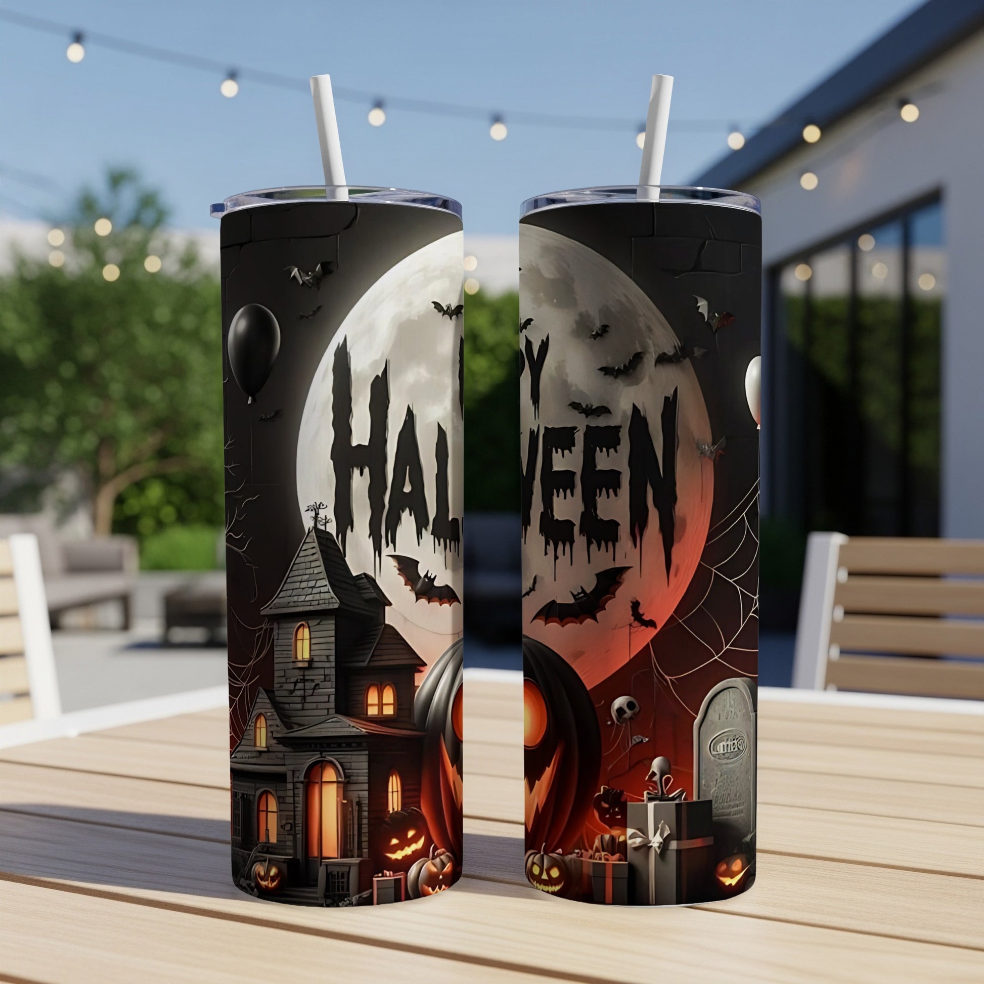 Two tumblers with a spooky Halloween design featuring a haunted house, pumpkins, bats, and a tombstone.