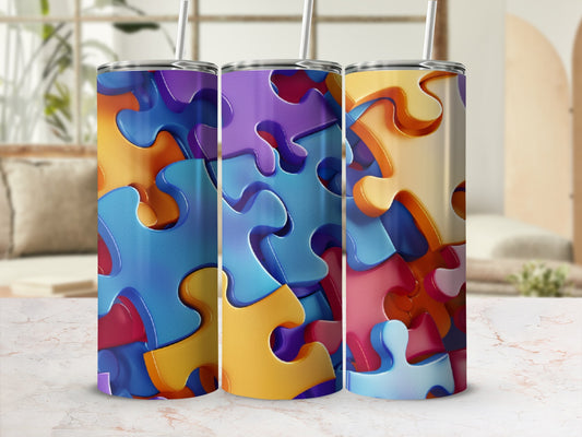 Three tumblers with colorful puzzle piece designs.