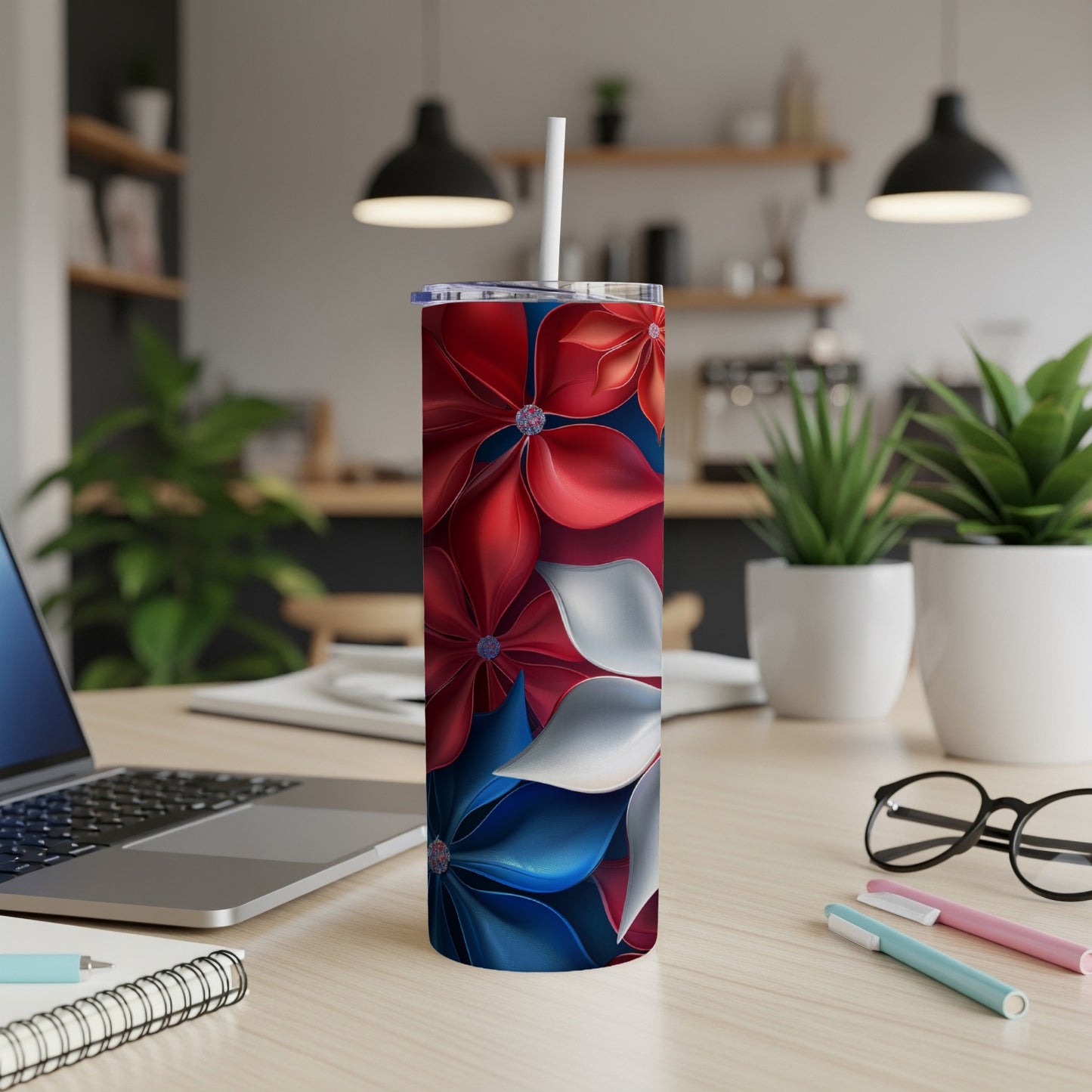 Red, white, and blue floral pattern on a stainless steel tumbler.